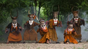 A group of performers wearing ghastly masks.