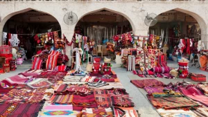 traditional carpets and garments on display at souq waqif market, doha